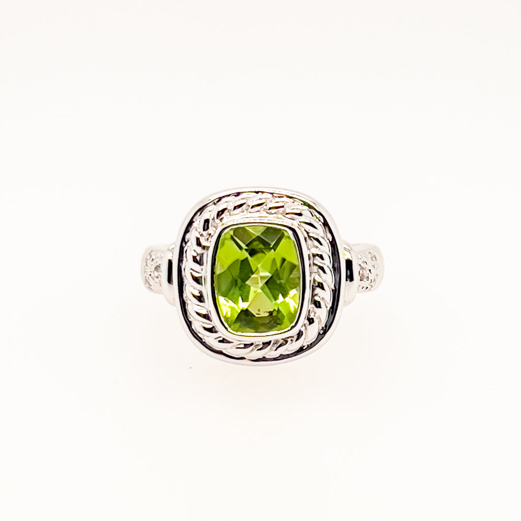Green gemstone ring with twisted white gold band.