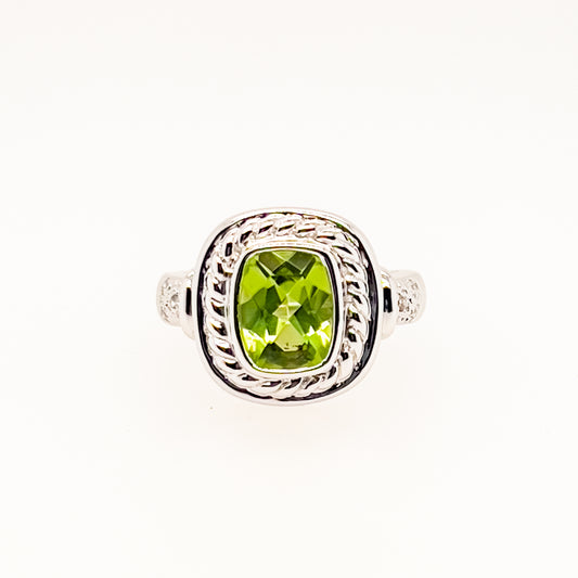 Green gemstone ring with twisted white gold band.