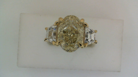 Three-stone yellow diamond engagement ring.