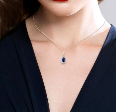 Oval sapphire pendant on white gold necklace.