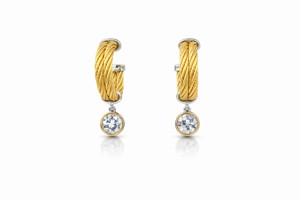 Gold twisted huggie earrings with diamonds.
