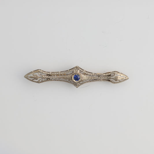 14k white gold filigree pin with sapphire.