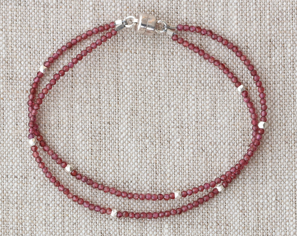 Red garnet bead bracelet with silver accents.