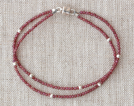 Red garnet bead bracelet with silver accents.