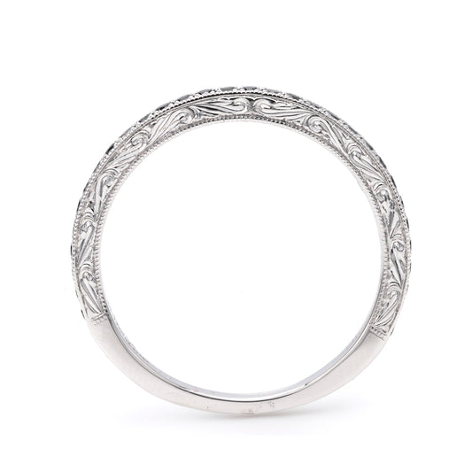 Intricate white gold band with engravings.