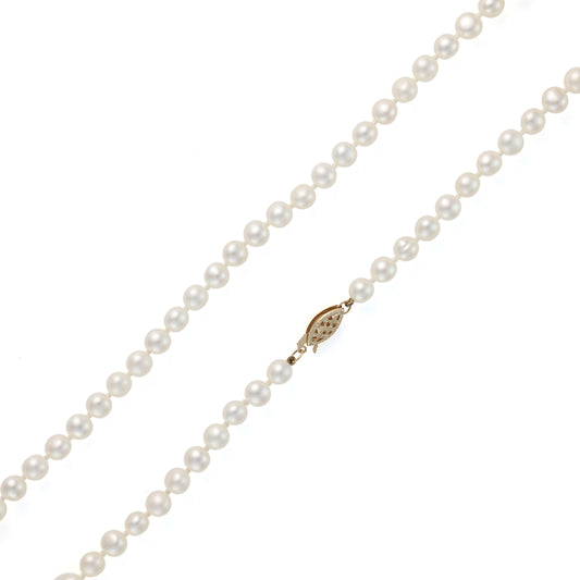 White pearl strand necklace with gold clasp.