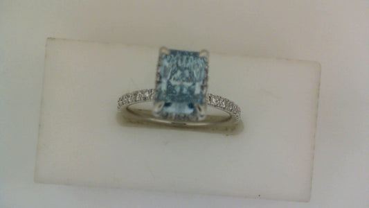 Blue diamond engagement ring with side stones.