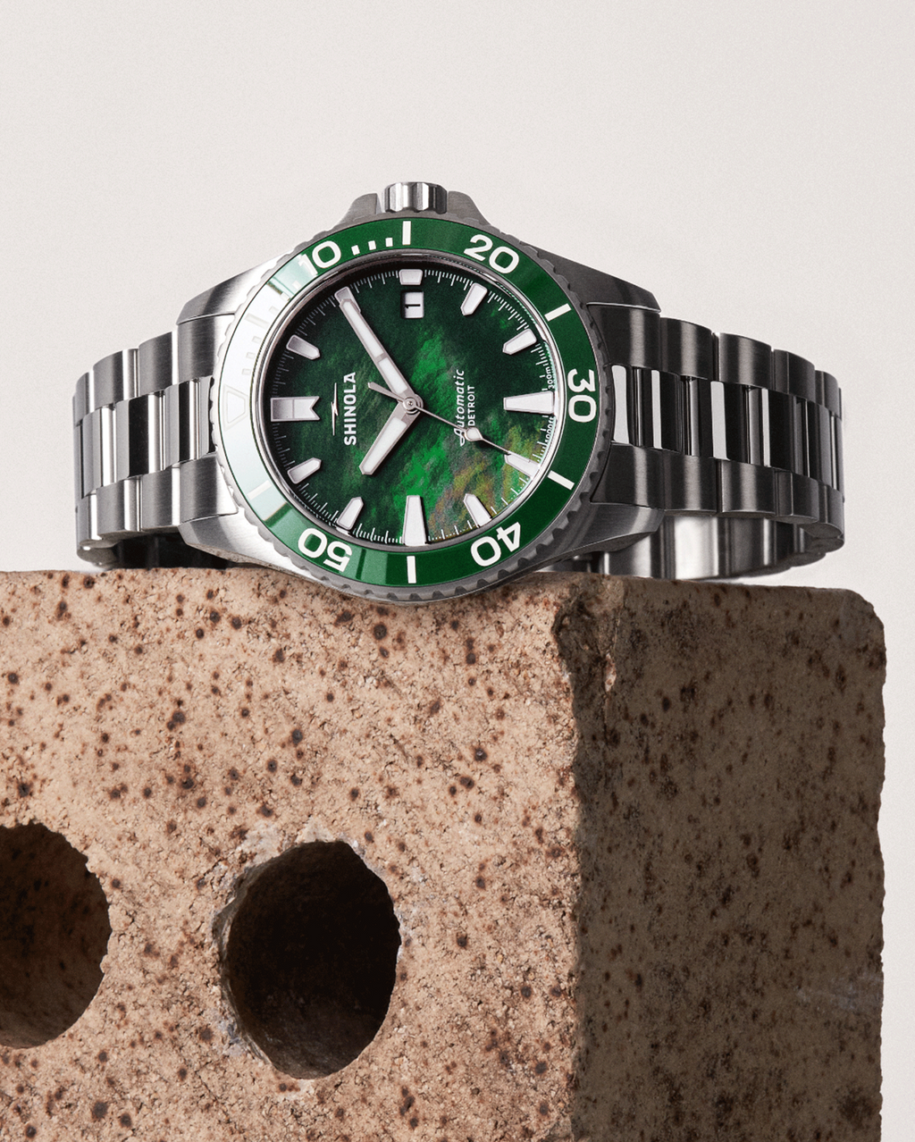 Stainless steel watch with green dial.