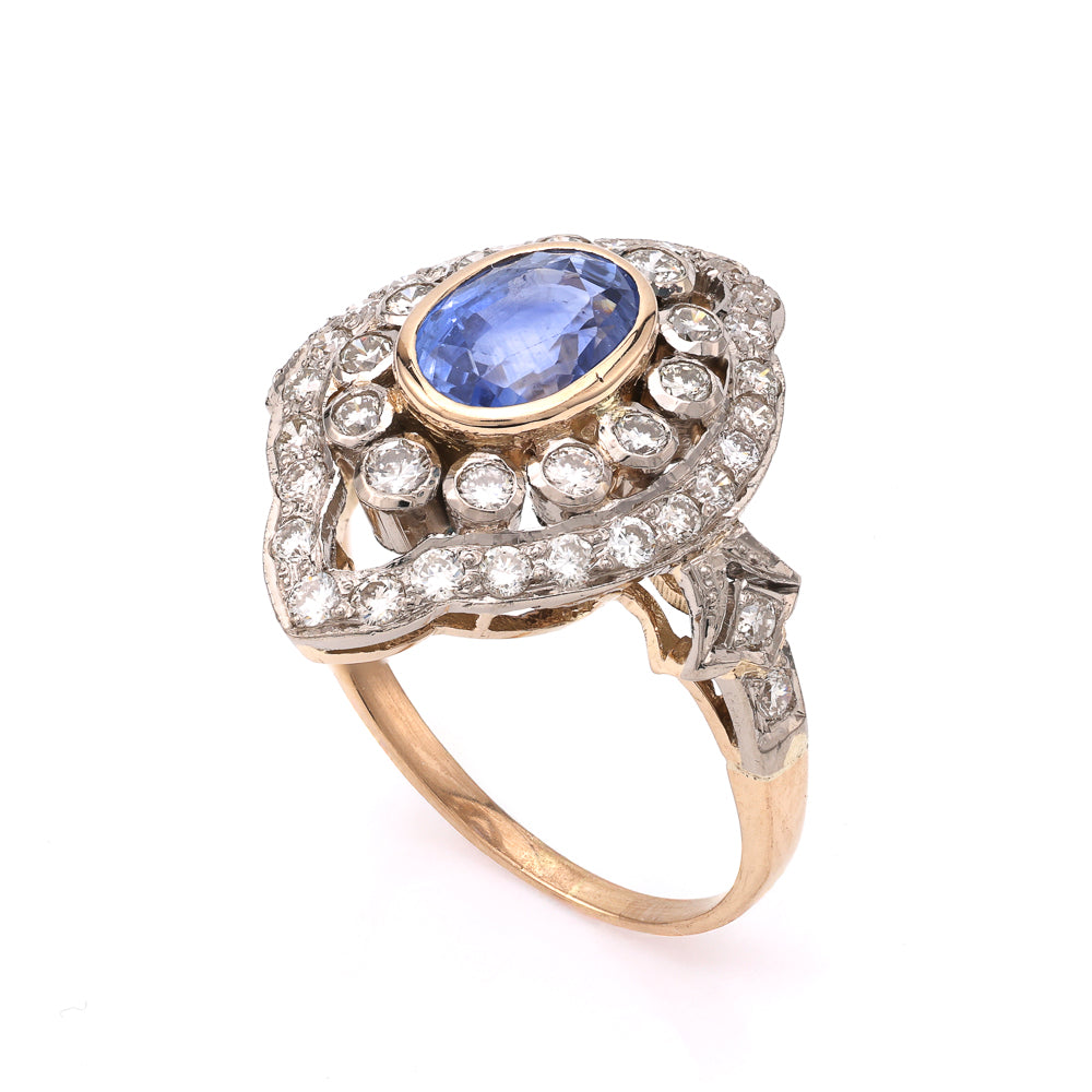 Oval blue sapphire ring with diamond accents.