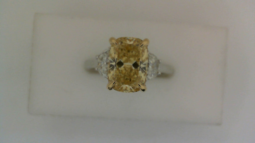 Yellow diamond three-stone engagement ring.