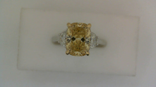 Yellow diamond three-stone engagement ring.