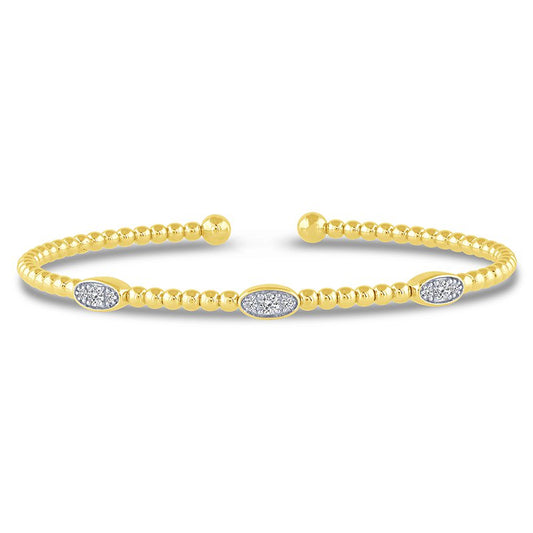 Yellow gold bracelet with round diamond accents.