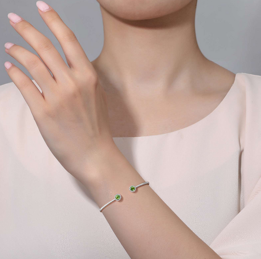 Peridot cuff bracelet on wrist.