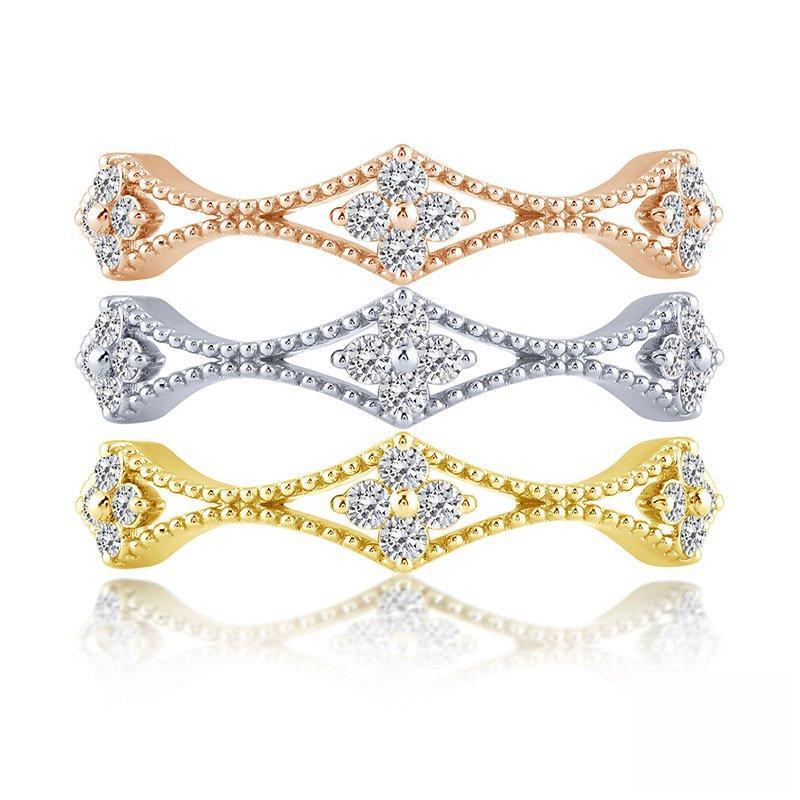 Three stackable diamond rings in gold tones.