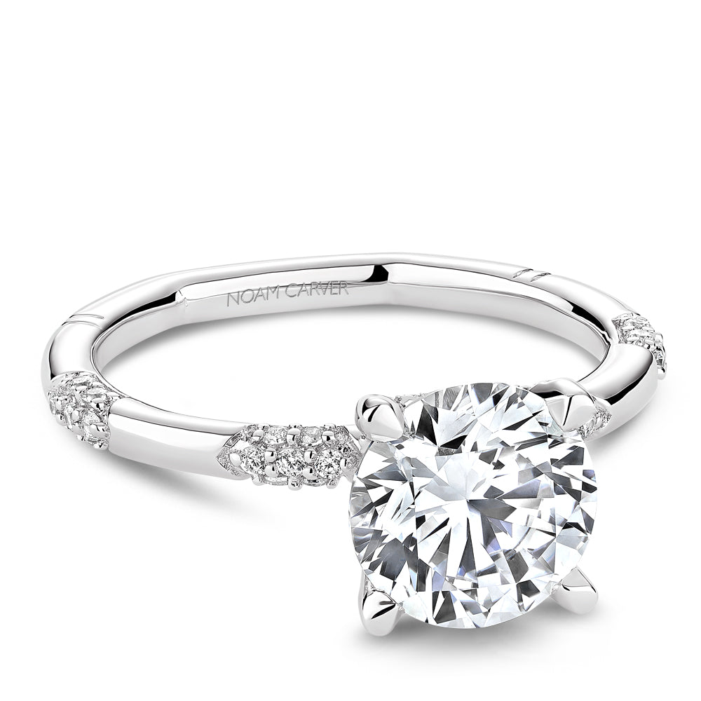 Solitaire diamond ring with accent stones.