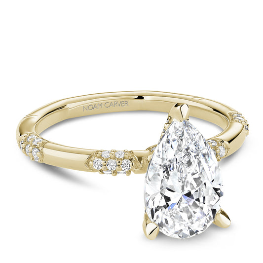 Yellow gold ring with pear-shaped diamond.