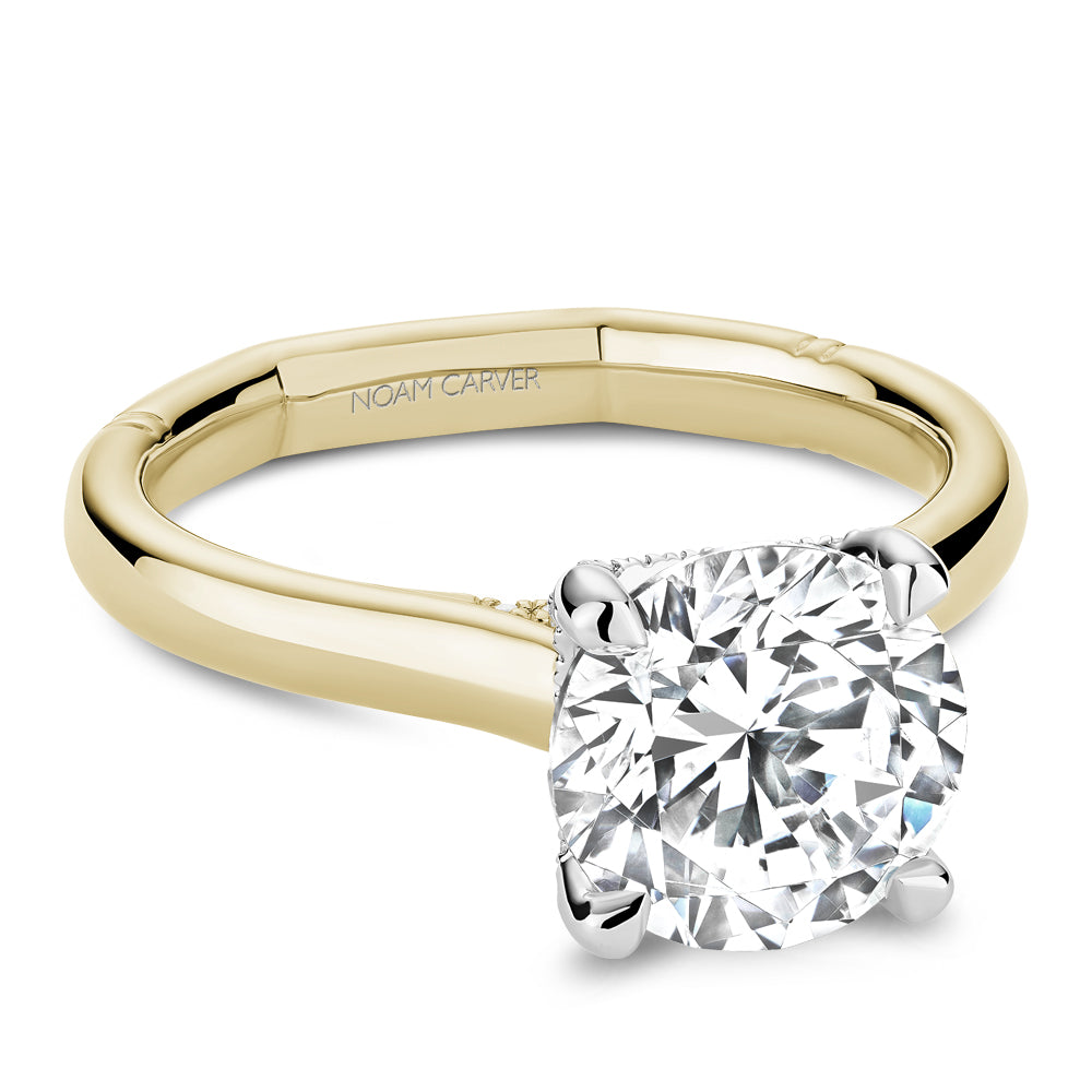Two-tone gold ring with round diamond.