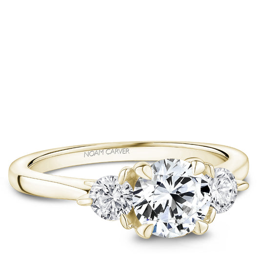Three-stone diamond yellow gold engagement ring.