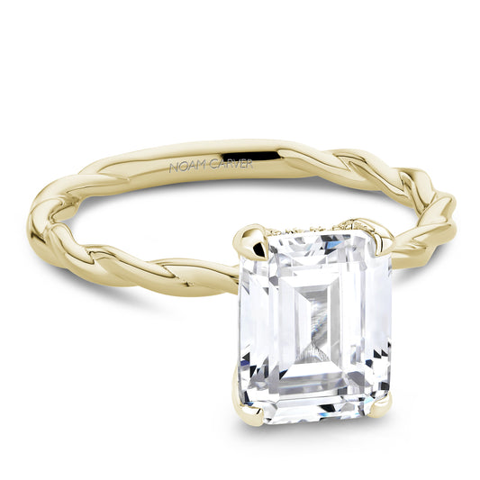 Twisted gold band with emerald-cut diamond.