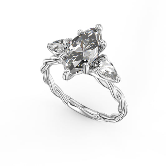 Three-stone diamond ring with pear accents.
