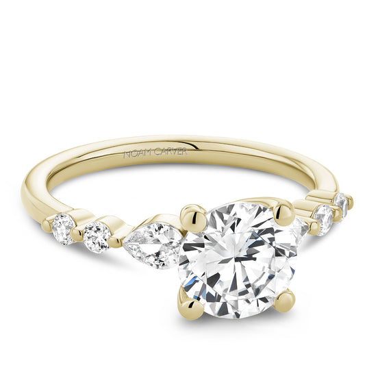 Yellow gold ring with pear and round diamonds.