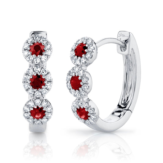 Ruby and diamond huggie earrings in white gold.
