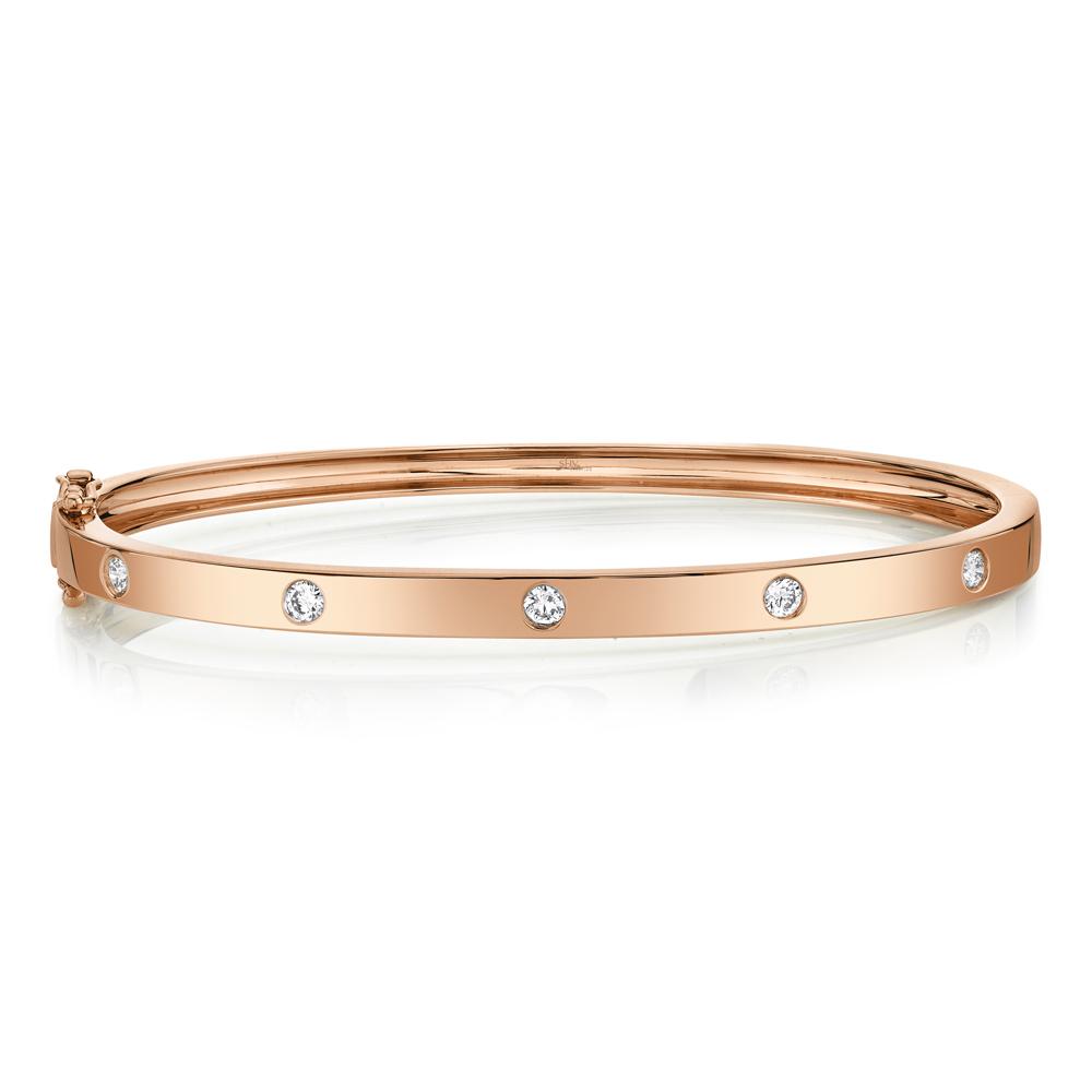 Rose gold bangle with round diamonds.