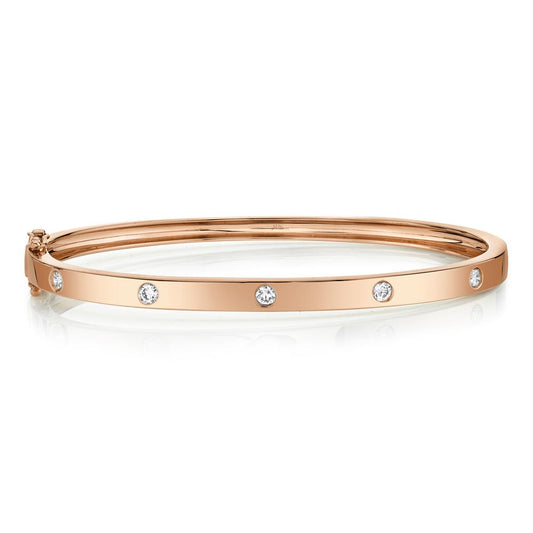 Rose gold bangle with round diamonds.