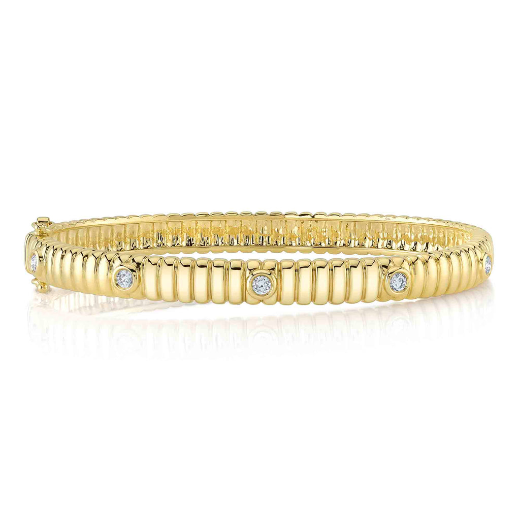 Yellow gold bangle with round diamonds.
