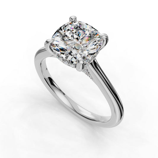 Cushion-cut diamond solitaire on platinum band.