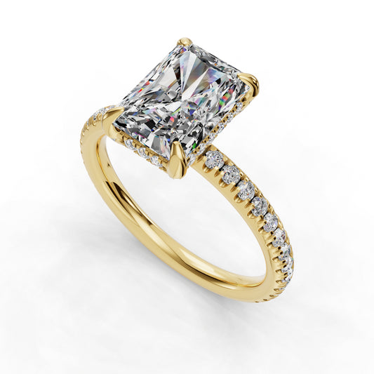 Radiant-cut diamond on gold band.