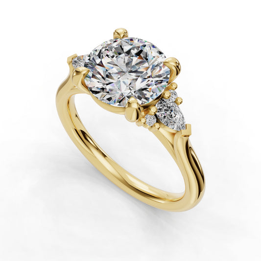 Gold ring with round and pear diamonds.