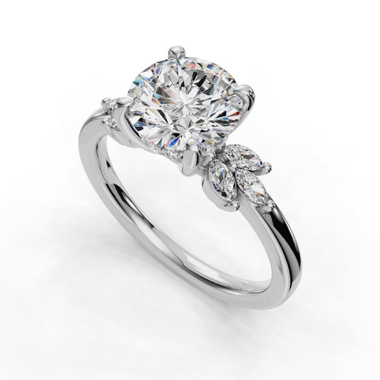 Round diamond ring with marquise side stones.