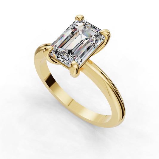 Emerald-cut diamond on gold band ring.