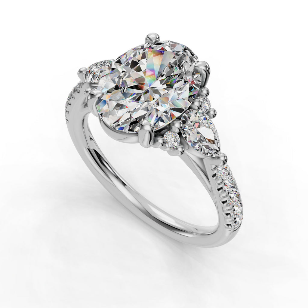 Oval diamond ring with pear and round accents.
