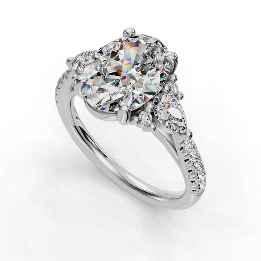Oval diamond ring with pear and round accents.