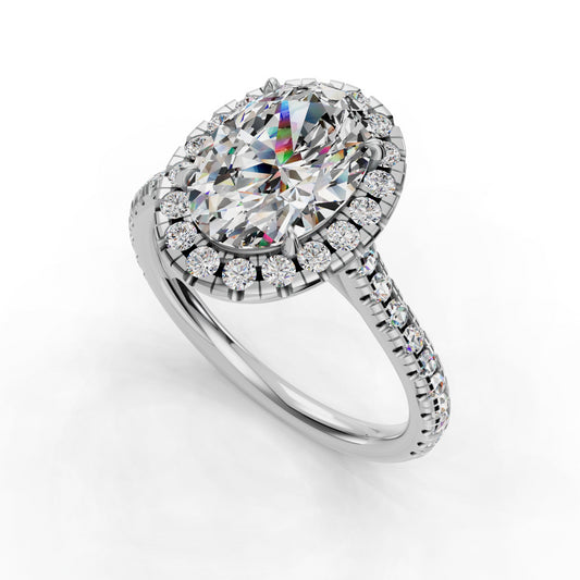 Oval diamond ring with halo and pavé band.