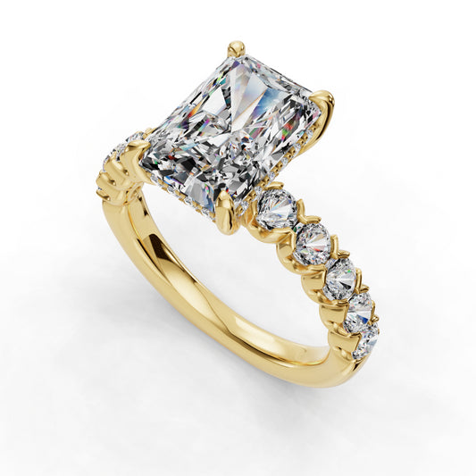 Gold ring with radiant-cut diamond centerpiece.