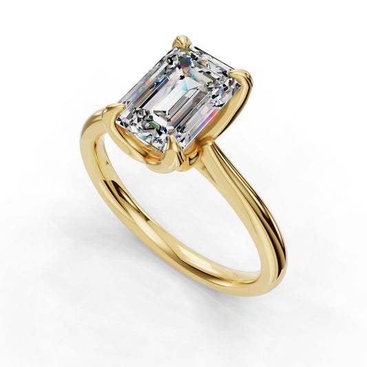 Emerald-cut diamond on gold band ring.