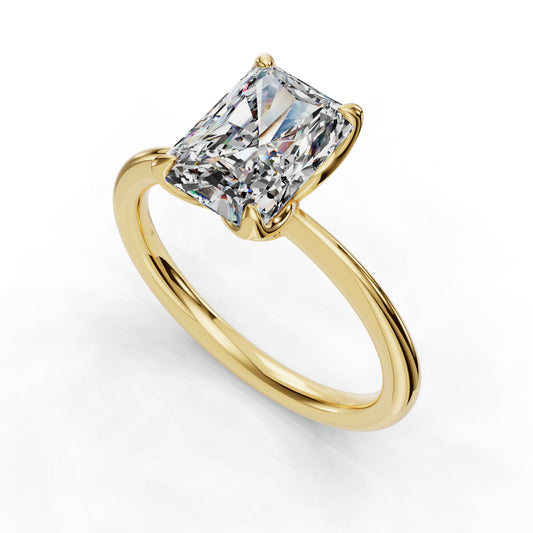 Gold ring with radiant-cut diamond solitaire.