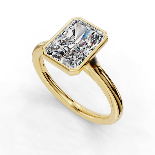 Gold ring with rectangular diamond solitaire.