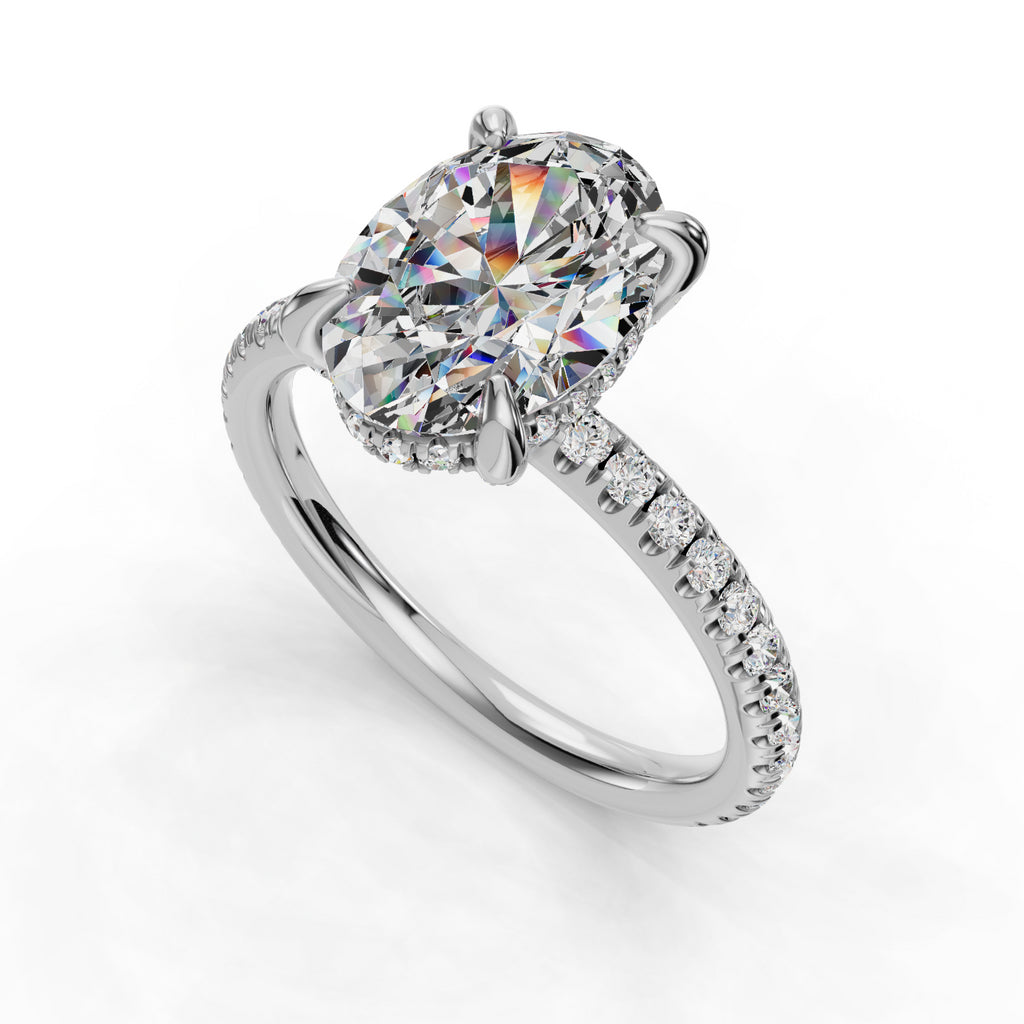 Oval diamond ring with pavé band.