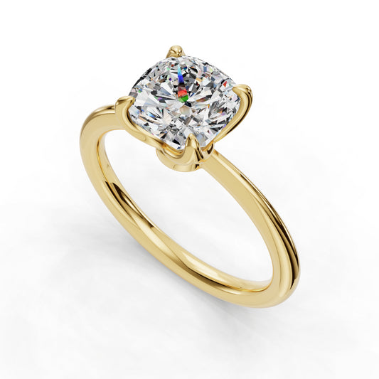 Gold ring with cushion-cut diamond solitaire.