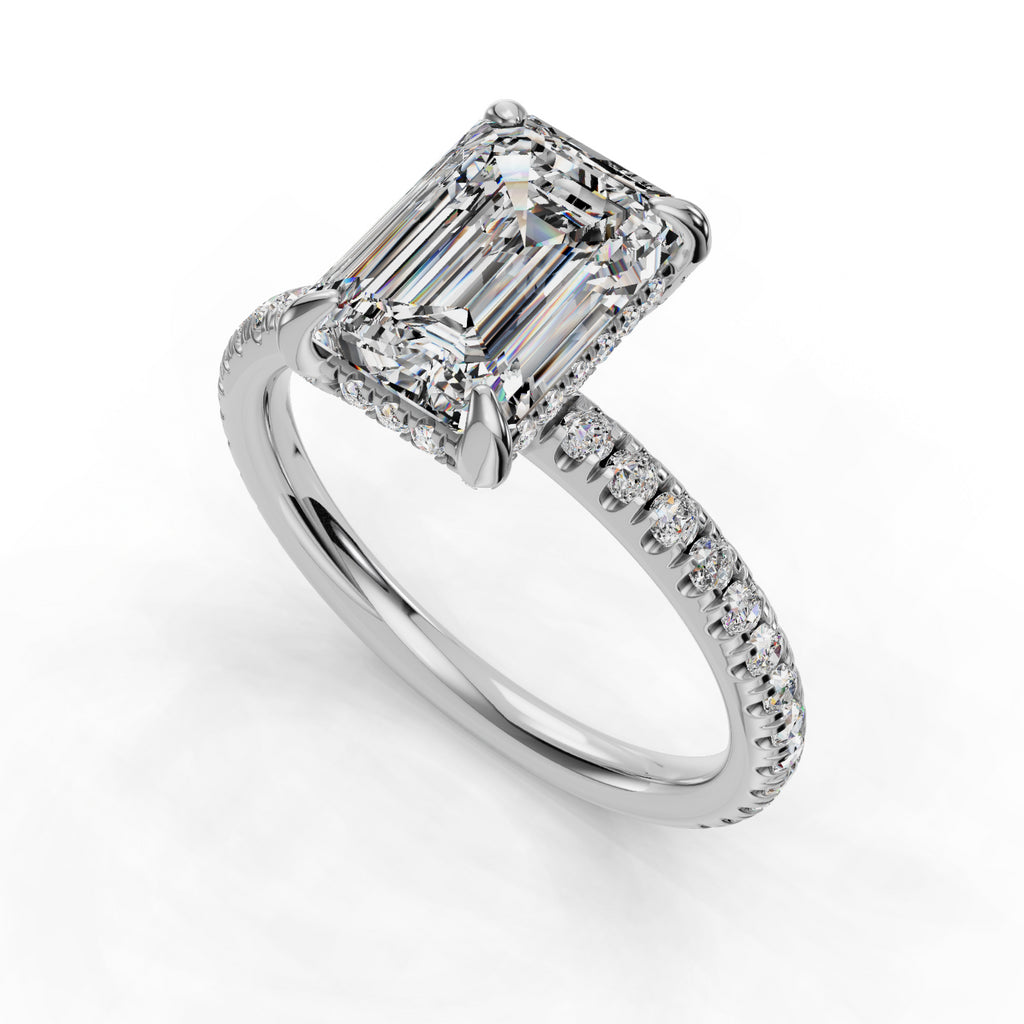 Emerald-cut diamond ring with pavé band.