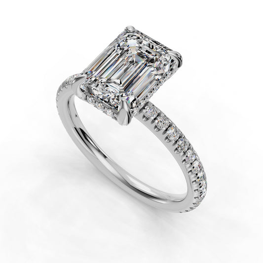 Emerald-cut diamond ring with pavé band.