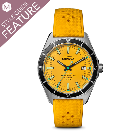 Yellow dial watch with stainless steel case.