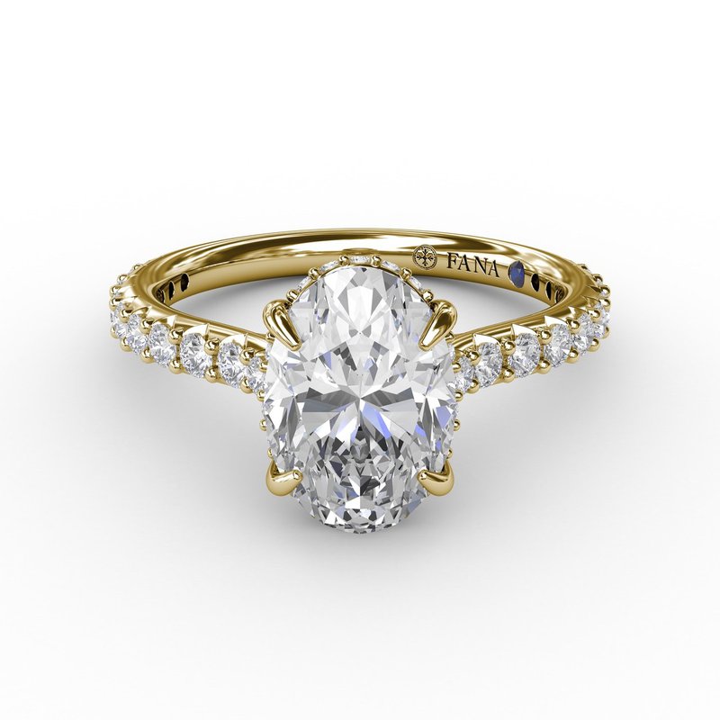 Yellow gold ring with oval diamond centerpiece.