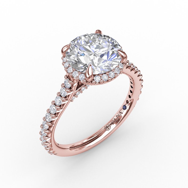 Rose gold diamond halo engagement ring.