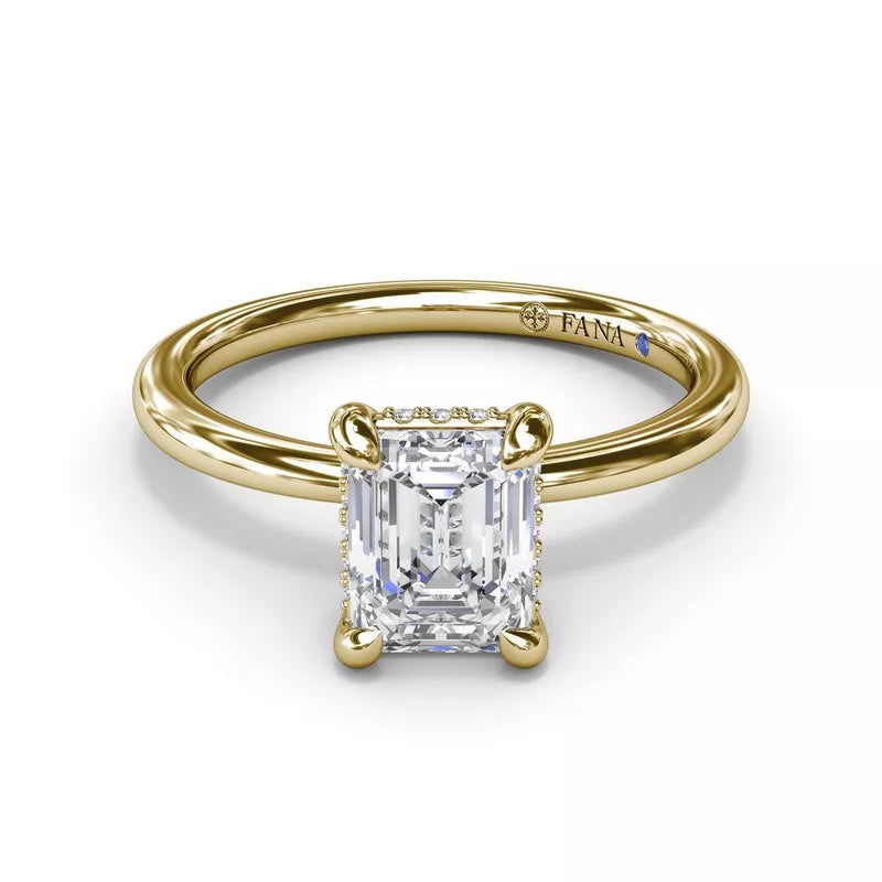 Yellow gold ring with rectangular diamond setting.