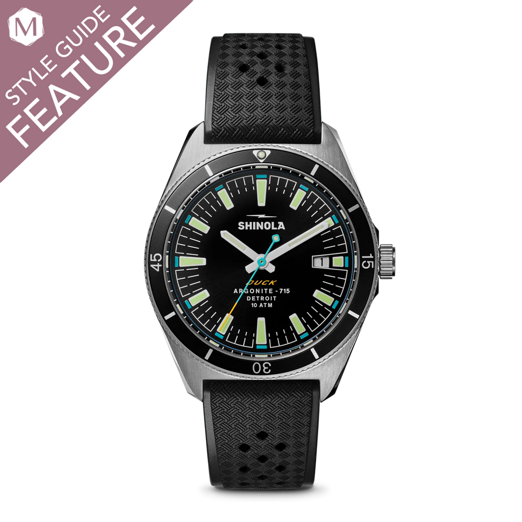 Black dial watch with rubber strap.